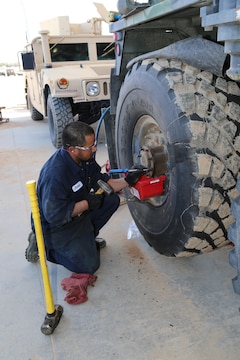 Javier Lopez, heavy mobile equipment repairman with ECS 171, makes fine adjustments to the wheel base of a Hemet Wrecker at ECS 171 aboard Marine Corps Logistics Base Barstow's Yermo Annex, Feb. 4.  ECS 171 employees maintain and store various types of equipment for use by Army units rotating to Fort Irwin for training. 