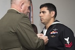 Marine Corps Maj. Gen. Joseph L. Osterman presents Navy Petty Officer 2nd Class Alejandro Salabarria a Silver Star medal during a ceremony at Camp Lejeune, N.C., Feb. 5, 2016. Marine Corps photo