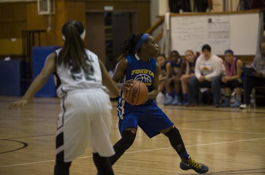 A Yokota Panthers player from Yokota Air Base, Japan, looks for an opening during the  2016 Division 2 Girls’ Far East Basketball Tournament championship game at Matthew C. Perry High School at Marine Corps Air Station Iwakuni, Japan, Feb. 18, 2016. The Zama Trojans from Camp Zama, Japan, and the Yokota Panthers made it to the championships after competing in brackets all week. The Panthers came out victorious with a 50-24 point win.