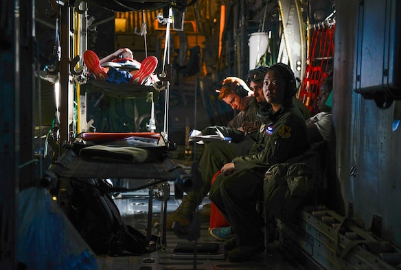 Capt. Melissa Cadorette, a flight nurse with the 18th Aeromedical Evacuation Squadron, listens to crew communications aboard a C-130 Hercules Feb. 15, 2016, during an expeditionary medical support exercise on the island of Rota. Exercise Cope North 16 enhances humanitarian assistance and disaster relief crisis response capabilities between six nations and lays the foundation for regional cooperation during real-world contingencies in the Indo-Asia-Pacific region. (U.S. Air Force photo/Staff Sgt. Alexander W. Riedel)