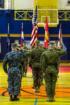 Service members with Headquarters and Headquarters Squadron, salute the colors during a relief and appointment ceremony at Marine Corps Air Station Iwakuni, Japan, Feb. 26, 2016. Sgt. Maj. Coleman Kinzer relinquished his duties as H&HS sergeant major to Sgt. Maj. Darnell Richardson. Richardson said he plans on becoming involved with the unit by encouraging Marines to willingly seek self-improvement.