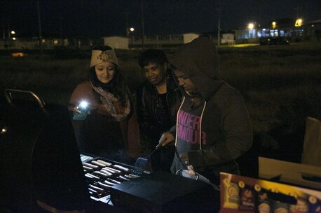 Volunteers grill hotdogs during a basketball game Jan. 1 on Marine Corps Air Station Futenma, Okinawa, Japan. The volunteers were part of on-base organizations such as the USO. The game was hosted by MCAS Futenma’s Single Marine Program and Navy Lt. Yonina E. Creditor, the station chaplain for MCAS Futenma. (Marine Corps Photo by Lance Cpl. Douglas D. Simons/Released)