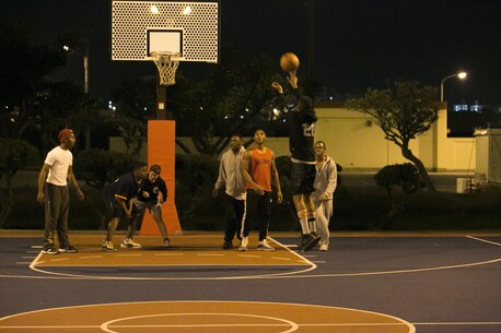 Status of Forces Agreement personnel participate in a basketball game Jan. 1 on Marine Corps Air Station Futenma, Okinawa, Japan. Participants received gift cards for competing at the end of the night. The game was hosted by MCAS Futenma’s Single Marine Program and Navy Lt. Yonina E. Creditor, the station chaplain for MCAS Futenma. (Marine Corps Photo by Lance Cpl. Douglas D. Simons/Released)