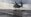 A CH-53E from Marine Heavy Helicopter Squadron (HMH) 465 hovers above as Marines with Combat Logistic Battalion (CLB) 11 rush in to attach 6,200-pound weight to the helicopter aboard Marine Corps Air Station Miramar, Calif., Jan. 7. Marines with CLB-11 support HMH-465 during daytime external lift training to prepare for future deployments. (U.S. Marine Corps photo by Lance Cpl. Harley Robinson/Released)