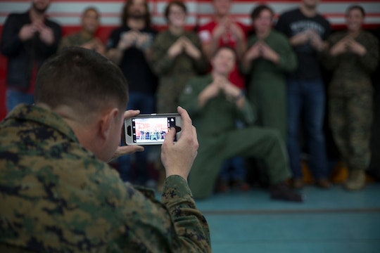 Aircraft rescue and firefighting Marines with Headquarters and Headquarters Squadron pose for a group picture with 3 Doors Down during their visit to Marine Corps Air Station Iwakuni, Japan, Jan. 14, 2016. Members of the band said they do these tours in order to give back to the men and women who have already given so much.