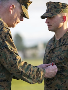 U.S. Marines Corps Maj. Gen. Niel E. Nelson, commander of U.S. Marine Corps Forces Europe and Africa awards Sgt. Matthew A. Sprankle the Navy and Marine Corps Medal, aboard Morón Air Base, Spain, Jan. 26, 2016, after saving a Senegalese man from drowning last August. The award is the highest non-combative decoration for heroism awarded by the U.S. Department of the Navy.  (U.S. Marine Corps photo by Sgt. Kassie L. McDole/Released)