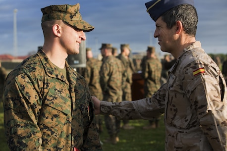 U.S. Marine Corps Sgt. Matthew A. Sprankle is congratulated by a Spanish Air Force Officer at Morón Air Base, Spain, Jan. 26, 2016, after receiving the Navy and Marine Corps Medal for saving a Senegalese man from drowning on last August. The award is the highest non-combative decoration for heroism awarded by the U.S. Department of the Navy.  (U.S. Marine Corps photo by Sgt. Kassie L. McDole/Released)