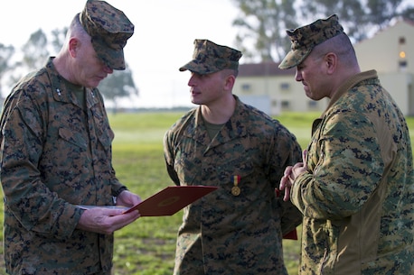U.S. Marine Corps Maj. Gen. Niel E. Nelson, commander of U.S. Marine Corps Forces Europe and Africa, (left), and Sgt. Maj. William R. Frye, Sergeant Major of U.S. Marine Corps Forces Europe & Africa (right), discuss Sgt. Matthew A. Sprankle, Special-Purpose Marine Air-Ground Task Force Crisis Response-Africa (middle) actions after receiving the Navy and Marine Corps Medal, aboard Morón Air Base, Spain, Jan. 26, 2016, for saving a Senegalese man from drowning last August. The award is the highest non-combative decoration for heroism awarded by the U.S. Department of the Navy.  (U.S. Marine Corps photo by Sgt. Kassie L. McDole/Released)