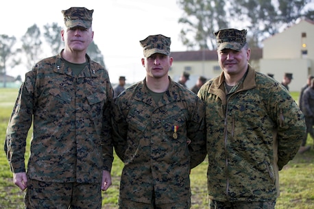 U.S. Marine Corps Maj. Gen. Niel E. Nelson, commander of U.S. Marine Corps Forces Europe and Africa, (left), and Sgt. Maj. William R. Frye, Sergeant Major of U.S. Marine Corps Forces Europe & Africa (right), pose for a photo with Sgt. Matthew A. Sprankle, after he received the Navy and Marine Corps Medal aboard Morón Air Base, Spain, Jan. 26, 2016, for saving a Senegalese man from drowning last August. The award is the highest non-combative decoration for heroism awarded by the U.S. Department of the Navy.  (U.S. Marine Corps photo by Sgt. Kassie L. McDole/Released)