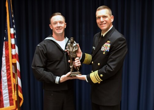 WASHINGTON (Jan. 21, 2016) Hospital Corpsman 1st Class Mark Francesco, from Atlantic City, N.J. receives a trophy from Vice Adm. Dixon Smith, commander of Navy Installations Command (CNIC) for his selection as 2015 CNIC Sailor of the Year. (U.S. Navy photo by Mass Communication Specialist 1st Class John Belanger/Released)