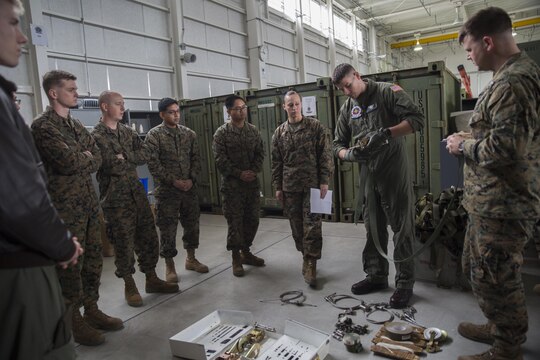 Sgt. Chris McClellan, KC-130J Super Hercules crew master with Marine Aerial Refueler Transport Squadron (VMGR) 152 at Marine Corps Air Station Iwakuni, Japan, demonstrates proper use and engagement of the Van Zelm ratchet during familiarization training Jan. 26, 2016. Using an air drop kit, open discussion and hands-on learning, McClellan taught the class to a handful of crew masters and Marines in training.