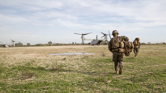 U.S. Marines with the Ground Combat Element, Special-Purpose Marine Air-Ground Task Force Crisis Response-Africa, run toward an MV-22B Osprey after recovering a simulated casualty during an alert-force drill at Naval Station Rota, Spain, January 23, 2016. SPMAGTF-CR-AF is a self-sustaining crisis-response force prepared for the protection of American personnel and facilities on the African continent when directed.