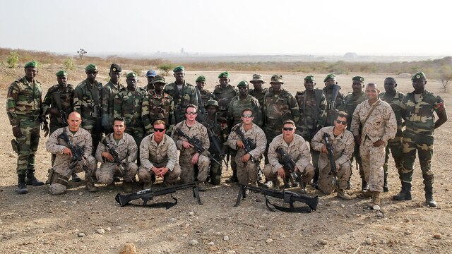 Marines with Special Purpose Marine Air-Ground Task Force Crisis Response-Africa pose for a picture with the Compagnie Fusilier de Marin Commando in Thies, Senegal, June 22, 2016. Marines and the COFUMACO conducted a three-week training exercise that included advanced combat firing techniques, a machine gun range and a live-fire platoon attack range.