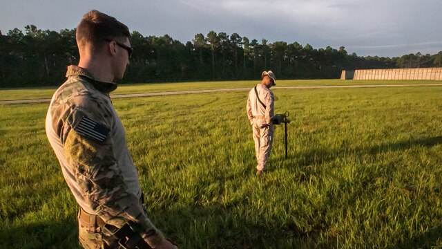 Senior Airman Christian Hulsey, an explosive ordnance technician with 4th civil engineer squadron, sweeps the ground for unexploded ordnance alongside a Marine with 2nd Explosive Ordnance Disposal Company during a field exercise at Marine Corps BaseCamp Lejeune, N.C., June 30, 2016. The field exercise was a weeklong event in which Marines and airmen trained together to enhance their skills as EOD techs. 