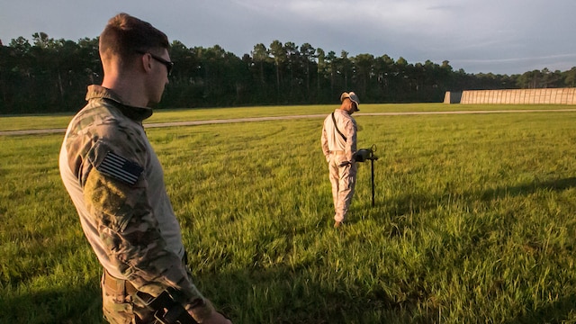 Senior Airman Christian Hulsey, an explosive ordnance technician with 4th civil engineer squadron, sweeps the ground for unexploded ordnance alongside a Marine with 2nd Explosive Ordnance Disposal Company during a field exercise at Marine Corps BaseCamp Lejeune, N.C., June 30, 2016. The field exercise was a weeklong event in which Marines and airmen trained together to enhance their skills as EOD techs. 