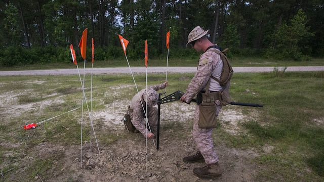 Marines with 2nd Explosive Ordnance Disposal plot the land as they search for potential unexploded ordnance during a field training exercise at Marine Corps Base Camp Lejeune, N.C., June 30, 2016. The training was a weeklong event that evaluated the Marines on their abilities to be successful EOD technicians.
