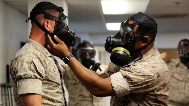 Sgt. Maj. Brian Taylor, sergeant major for Chemical Biological Incident Response Force, CBIRF, U.S. Marine Corps Forces Command, checks the M53 Chemical-Biological Protective Mask of Lance Cpl. John N. Barnett, a motor vehicle operator with H&S company for CBIRF, during gas mask drills on June 7. The Gas Mask Drill was to ensure all the Marines and Sailors are proficient to meet the nine second limit to successfully put on a gas mask in case of any real threat. The drill is necessary to ensure CBIRF’s ability to be ready at any moment’s notice.