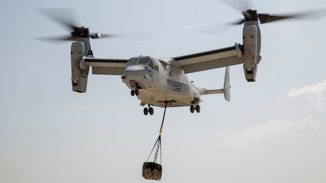 An MV-22 Osprey with Marine Medium Tiltrotor Squadron 263, Special Purpose Marine Air-Ground Task Force-Crisis Response-Africa, lifts a 1,098 pound pallet of Meals, Ready to Eat during a helicopter support team exercise at Naval Station Rota, Spain, July 6, 2016. External lifts allow pilots to deliver large cargo and supplies to Marines located in rough or unknown terrain without having to land the aircraft.