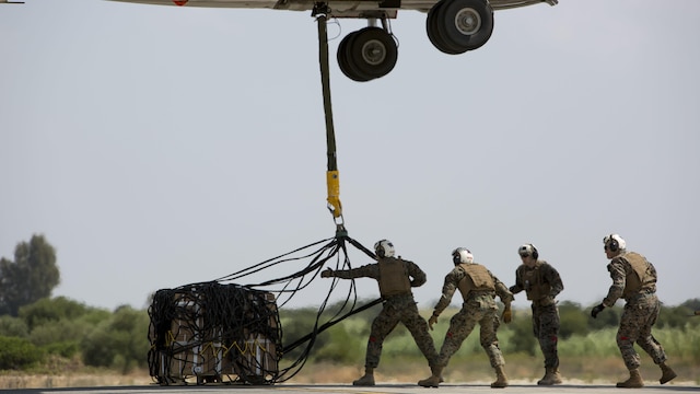 Landing support specialists with Combat Logistics Battalion 2, Special Purpose Marine Air-Ground Task Force-Crisis Response-Africa, attach a 1,098 pound pallet of Meals, Ready to Eat to an MV-22B Osprey during a helicopter support team exercise at Naval Station Rota, Spain, July 6, 2016. External lifts allow pilots to deliver large cargo and supplies to Marines located in rough or unknown terrain without having to land the aircraft.