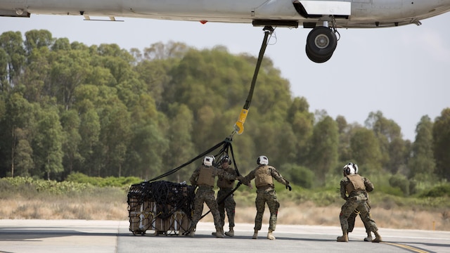 Landing support specialists with Combat Logistics Battalion 2, Special Purpose Marine Air-Ground Task Force-Crisis Response-Africa, attach a 1,098 pound pallet of Meals, Ready to Eat to an MV-22B Osprey during a helicopter support team exercise at Naval Station Rota, Spain, July 6, 2016. This training prepares Marines to deliver and recover supplies and equipment quickly and efficiently in potential future missions around Europe and Africa.