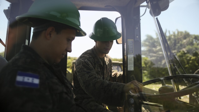 Cpl. Ivan A. Barbosa, a heavy equipment operator with Special Purpose Marine Air-Ground Task Force - Southern Command, conducts a period of instruction on basic operation and capabilities of a 624KR TRAM during a construction project between Honduran service members and U.S. Marines at Puerto Castilla, Honduras, June 24, 2016. The Marines worked side by side Honduran engineers on different construction and restoration projects, and shared knowledge and experience on techniques including maintenance and operation of heavy equipment.