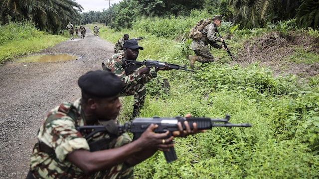 Cpl. Mitchell York, a rifleman with Special Purpose Marine Air-Ground Task Force Crisis Response-Africa, rushes forward during a simulated contact left attack during a patrolling exercise with Cameroonian soldiers with Forces Fusiliers Marins et Palmeurs de Combat in Limbé, Cameroon, June 28, 2016.