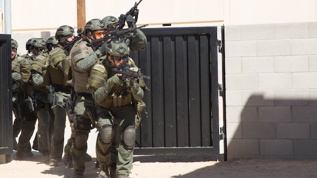 Deputy sheriffs with the San Bernardino County Sheriff’s Department Special Weapons and Tactics Team prepare to enter a building in the military operations in urban terrain facility at Range 800 at Marine Corps Air Ground Combat Center Twentynine Palms, Calif., July 12, 2016. The Combat Center’s Special Reaction Team hosted the cross-training to provide SBCSD with insight of the Marine Corps’ tactics capabilities. 
