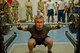Peter Olsen, Department of Defense civilian, prepares to stand up from the bottom of a squat during a power lifting competition, July 15, 2016, Bagram Airfield, Afghanistan. Olsen participated in a power lifting competition that included squats, bench press, and deadlifts organized by the 455th EAMXS. (U.S. Air Force photo by Capt. Korey Fratini)