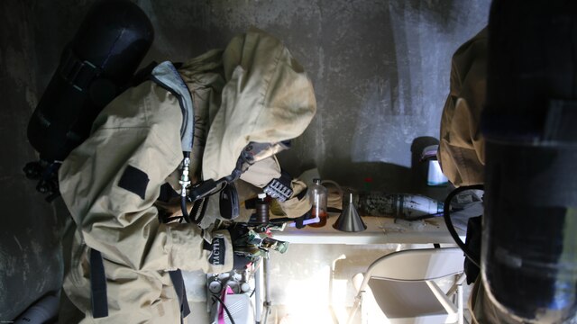 Lance Cpl. Ryan Shriver places chemical lights around a simulated incident site during a training exercise at Marine Corps Air Station Cherry Point, N.C., July 12, 2016. The training further refined the interoperability between MCAS Cherry Point’s Explosive Ordnance Disposal and 2nd Marine Aircraft Wing’s Chemical, Biological, Radiological and Nuclear Defense. Shriver is a CBRN defense specialist with Marine Wing Headquarters Squadron 2. 