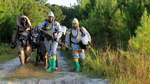 Marines with Marine Corps Air Station Cherry Point’s Explosive Ordnance Disposal and 2nd Marine Aircraft Wing’s Chemical, Biological, Radiological and Nuclear Defense walk toward a simulated incident site during a training exercise at MCAS Cherry Point, N.C., July 12, 2016. The training further refined the interoperability between EOD and CBRN. 