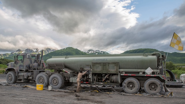 Cpl. Kuwyn Diggs, a semitrailer refueler operator with Detachment (-), Marine Wing Support Squadron-472, Marine Aircraft Group 49, 4th Marine Aircraft Wing, Marine Forces Reserve, performs maintenance on an AMK 970 semitrailer refueler during Innovative Readiness Training Old Harbor, Alaska, July 10, 2016. IRT Old Harbor is part of a civil and joint military program to improve military readiness while simultaneously providing quality services to underserved communities throughout the United States. (U.S. Marine Corps photo by Sgt. Ian Leones/released)