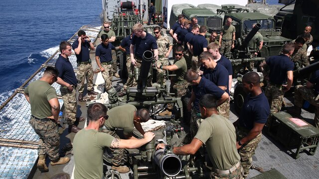 Marines with Battalion Landing Team, 1st Battalion, 6th Marine Regiment, 22nd Marine Expeditionary Unit, showcase an M327 120mm mortar and other capabilities to United Kingdom Royal Navy Marines aboard the amphibious dock landing ship USS Whidbey Island, July 8, 2016. 22nd MEU, deployed with the Wasp Amphibious Ready Group, is conducting naval operations in the U.S. 6th Fleet area of operations in support of U.S. national security interests in Europe. 