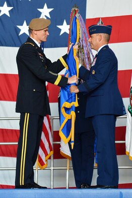 U.S. Army Gen. Joseph L. Votel, U.S. Central Command commander, passes the AFCENT guidon to U.S. Air Force Lt. Gen. Jeffrey L. Harrigian, U.S. Air Forces Central Command commander, during a change of command ceremony at Shaw Air Force Base, S.C., July 22, 2016. Outgoing and incoming commanders exchange a unit’s guidon to symbolize relinquishment and assumption of command. (U.S. Air Force photo by Airman 1st Class Christopher Maldonado/Released)