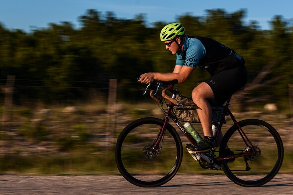 Staff Sgt. Kyle Emmel, a 17th Training Group student, cycles down a gravel road in San Angelo, Texas, July 18, 2016. Emmel is training for a race that stretches from Oregon to Virginia. The coast-to-coast race will be held in 2017. (U.S. Air Force photo/Senior Airman Devin Boyer)