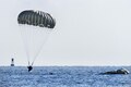 An Army Ranger lands after jumping from a Chinook helicopter during training off the coast of Tybee Island, Ga., July 20, 2016. Army photo by Sgt. William Begley