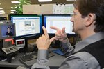 Michael Botte uses a video communication device provided through the Computer/Electronic Accommodations Program to make a call at Edwards Air Force Base, Calif., Sept. 22, 2014. Air Force photo by Jet Fabara