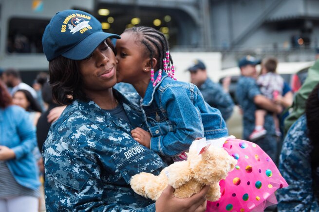 Navy Petty Officer 1st Class Donisha Brown reunites with her daughter during a homecoming celebration for the USS Ronald Reagan at Fleet Activities Yokosuka, Japan, July 26, 2016.The aircraft carrier participated in 53 days of strike group operations. Navy photo by Petty Officer 3rd Class James Lee