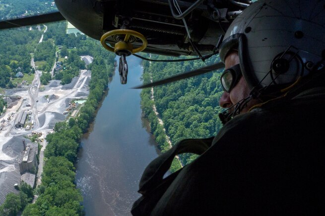 Navy Senior Chief Petty Officer Paul Morreira surveys a landing zone from an MH-53E Sea Dragon during training in mountainous terrain near Camp Dawson, W.Va., July 22, 2016. Morreira is a crewman assigned to Helicopter Mine Countermeasures Squadron 15. Navy photo by Petty Officer 1st Class Barry A. Riley