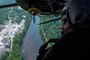 Navy Senior Chief Petty Officer Paul Morreira surveys a landing zone from an MH-53E Sea Dragon during training in mountainous terrain near Camp Dawson, W.Va., July 22, 2016. Morreira is a crewman assigned to Helicopter Mine Countermeasures Squadron 15. Navy photo by Petty Officer 1st Class Barry A. Riley