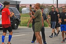 CAMP PENDLETON, Calif. -- Col. Reginald L. Hairston, commanding officer of SES Bn., Marine Corps Base Camp Pendleton, Marine Corps Installations – West, receives the Special Olympics torch from runners of the Oceanside Police Department at the Camp Pendleton Main Gate, June 1. More than 30 Marines and police officers from the Security and Emergency Service Battalion and the Camp Pendleton Police Department participated in the 2016 Law Enforcement Torch Run in support of the Special Olympics.