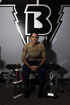 Staff Sgt. Annemarie E. Baker poses for a photo in the gym where she trained to win her first bodybuilding competition. Baker, a 14-year Marine and mother, attributed her decision to compete to her military career.