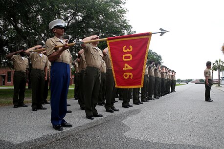 Pfc. Jacob J. Price, honor graduate of platoon 3046, presents his platoon's guidon as the rest of his platoon is saluting before the graduation ceremony, June 3rd, 2016, aboard Marine Corps Recruit Depot Parris Island, S.C. Price, a native of Crawfordville, Fla., was recruited by Staff Sgt. Jacob D. Melrose at Recruiting Substation Tallahassee. To be recommended as an honor graduate, a recruit must not only display honor, courage, and commitment during their three months of training but excel in physical training, knowledge, and have a team player disposition. (Official Marine Corps photo by Cpl. John-Paul Imbody)