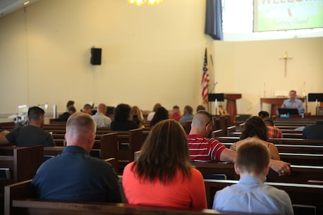 The members of Camp Courtney Chapel give a moment of silence for the tragic loss of a beautiful, young, Okinawan lady who was our neighbor, during the mourning service at the Camp Courtney Chapel on June 5, 2016.