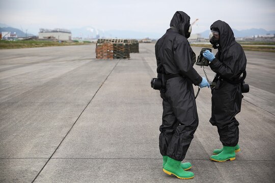 U.S. Marines from 3rd Marine Division, Chemical, Biological, Radiological and Nuclear defense platoon, Headquarters Battalion, III Marine Expeditionary Force, prepare to respond to contaminated cargo during exercise Habu Sentinel 16 at Marine Corps Air Station Iwakuni, Japan, June 7, 2016. Marine Aerial Refueler Transport Squadron (VMGR) 152, stationed at MCAS Iwakuni, assisted in the scenario by providing a taxiway combat off-load. Pallets suspected of radiological contamination slid from the cargo bay of a KC-130J Super Hercules onto the taxiway where CBRN Marines were staged nearby in order to respond swiftly and effectively.  As the annual capstone exercise for the division’s response element, this event encompasses multiple objectives specific to CBRN response and validates unit standard operating procedures in an unfamiliar training environment. (U.S. Marine Corps photo by Sgt. Jessica Quezada/Released)