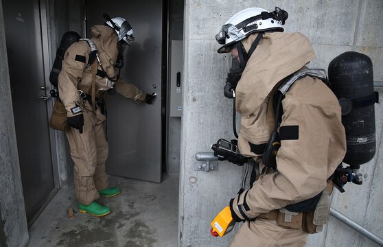 U.S. Marines from 3rd Marine Division, Chemical, Biological, Radiological and Nuclear defense platoon, Headquarters Battalion, III Marine Expeditionary Force, prepare to enter a room suspected of hazardous materials during exercise Habu Sentinel 16 at Disaster Village, Marine Corps Air Station Iwakuni, Japan, June 7, 2016. As the annual capstone exercise for the division’s response element, this event encompasses multiple objectives specific to CBRN response and validates unit standard operating procedures in an unfamiliar training environment. (U.S. Marine Corps photo by Sgt. Jessica Quezada/Released)