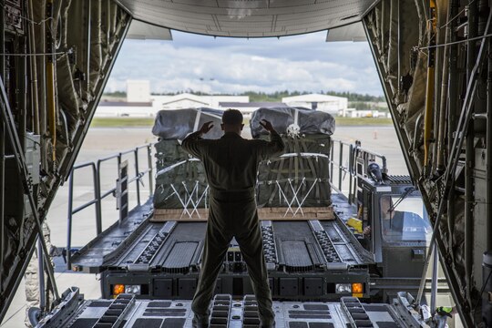 U.S. Marine Corps Lance Cpl. Tony Garcia, a crew chief in-training for Marine Aerial Refueler Transport Squadron 152, from Marine Corps Air Station Iwakuni, Japan, prepares to load cargo onto a KC-130J Super Hercules during exercise Kodiak Mace, May 25, 2016. The squadron utilized cargo from the 4th Infantry Brigade Combat Team, 25th Infantry Division at Joint Base Elmendorf-Richardson, Alaska, in support of exercise Kodiak Mace. Kodiak Mace is an annual joint exercise designed to give the U.S. Marine crew chiefs in-training the opportunity to earn qualifications and eventually the title of crew chief. (U.S. Marine Corps photo by Cpl. Cory Schubert/Released)