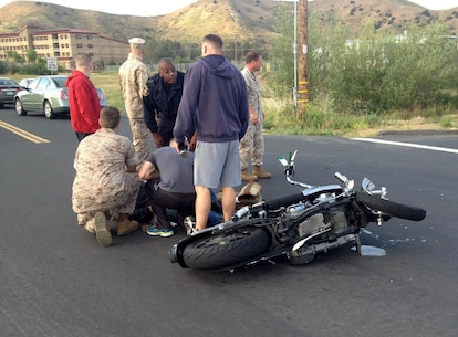 U.S. Marine Sgt. Brandon Jackson is treated for injuries sustained in a motorcycle accident by corpsmen aboard Camp Pendleton, Calif., May 23, 2016. Jackson, an airframes mechanic instructor at the Center for Naval Aviation Technical Training,was on his daily commute to work when he collided with a passenger vehicle. He sustained only minor injuries in the accident. (Courtesy Photo)