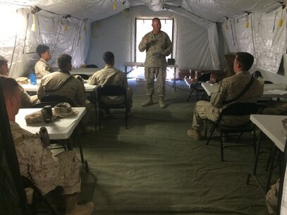 Lt. Cmdr. Paul Greer speaks to service members at a religous meeting during Weapons and Tactics Instructor Course 2-16 Field Exercise at Marine Corps Air Station Yuma, Ariz., March 27, 2016. Greer was recogized for the 2016 Military Chaplains Association Distinguished Service Award, and will recieve the award in Oct. 2016. The award recognizes one representative from each branch of service for their performance and dedication to the troops while serving as a chaplain. Greer is the chaplain for Marine Aircraft Control Group 28, and is the second 2nd MAW chaplain to win the award for the Marine Corps in the past two years. (U.S. Navy photo by Petty Officer 3rd Class Alexis McDaniel/Released)