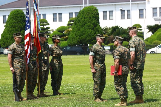 U.S. Marine Corps Col. Daniel Shipley, Marine Aircraft Group 12 commanding officer, awards Lt. Col. Kolter R. Miller, outgoing Marine Aviation Logistics Squadron 12 commanding officer, with a meritorious service medal during his change of command ceremony at Marine Corps Air Station Iwakuni, Japan, June 10, 2016. Miller relinquished his authority to Lt. Col. John A. Fallon, former MALS-12 executive officer. This ceremony symbolizes the end of Miller’s tour after assuming the role as commanding officer of MALS-12 in June 2014. (U.S. Marine Corps photo by Cpl. Justin Fisher/Released)