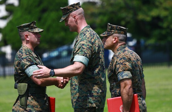 U.S. Marine Corps Col. Daniel Shipley, Marine Aircraft Group 12 commanding officer shakes hands with Lt. Col. Kolter R. Miller, outgoing Marine Aviation Logistics Squadron 12 commanding officer, after awarding him with a meritorious service medal during his change of command ceremony at Marine Corps Air Station Iwakuni, Japan, June 10, 2016. Miller relinquished his authority to Lt. Col. John A. Fallon, former MALS-12 executive officer. This ceremony symbolizes the end of Miller’s tour after assuming the role as commanding officer of MALS-12 in June 2014. (U.S. Marine Corps photo by Cpl. Justin Fisher/Released)